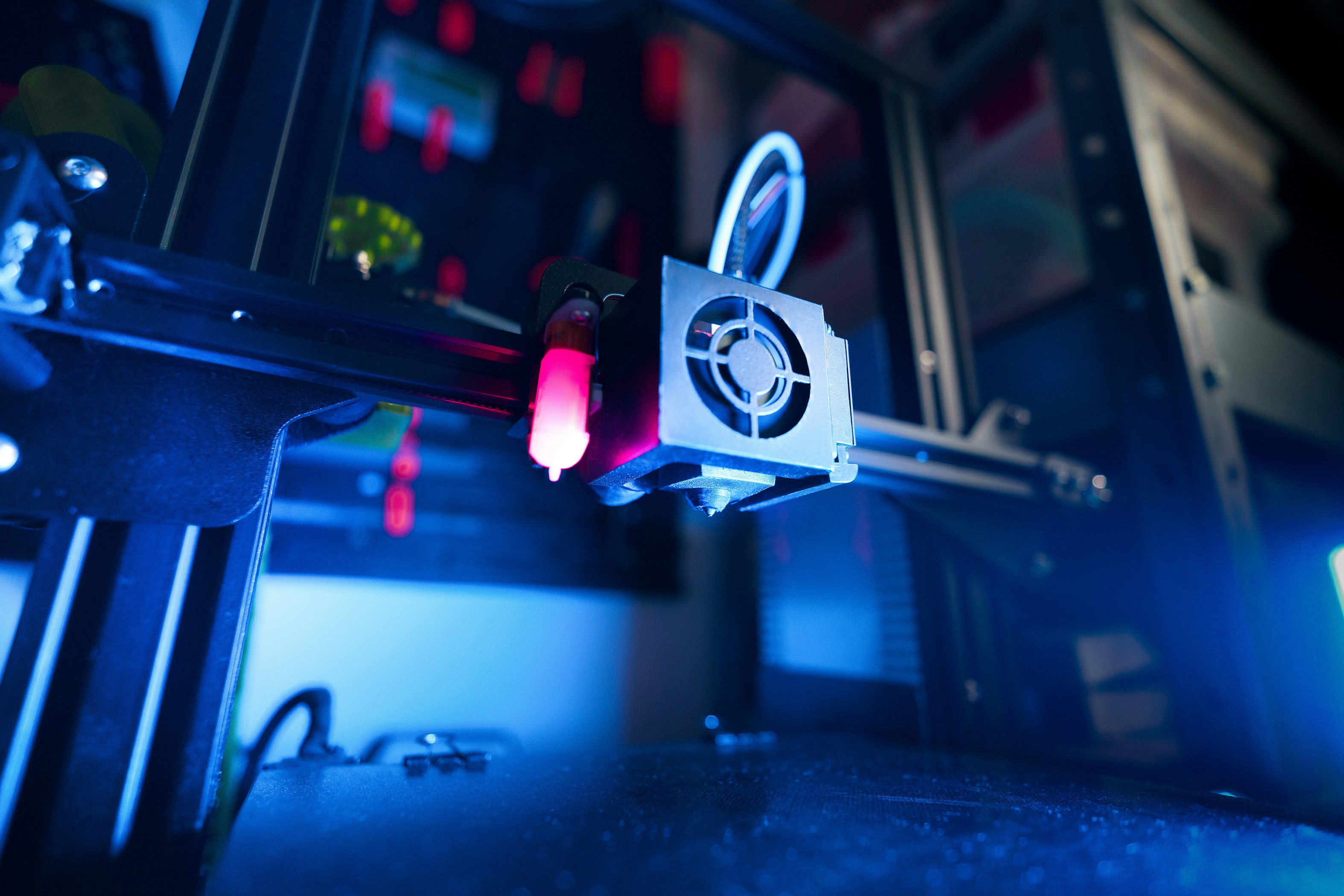 A 3D printer with a blue light on it.