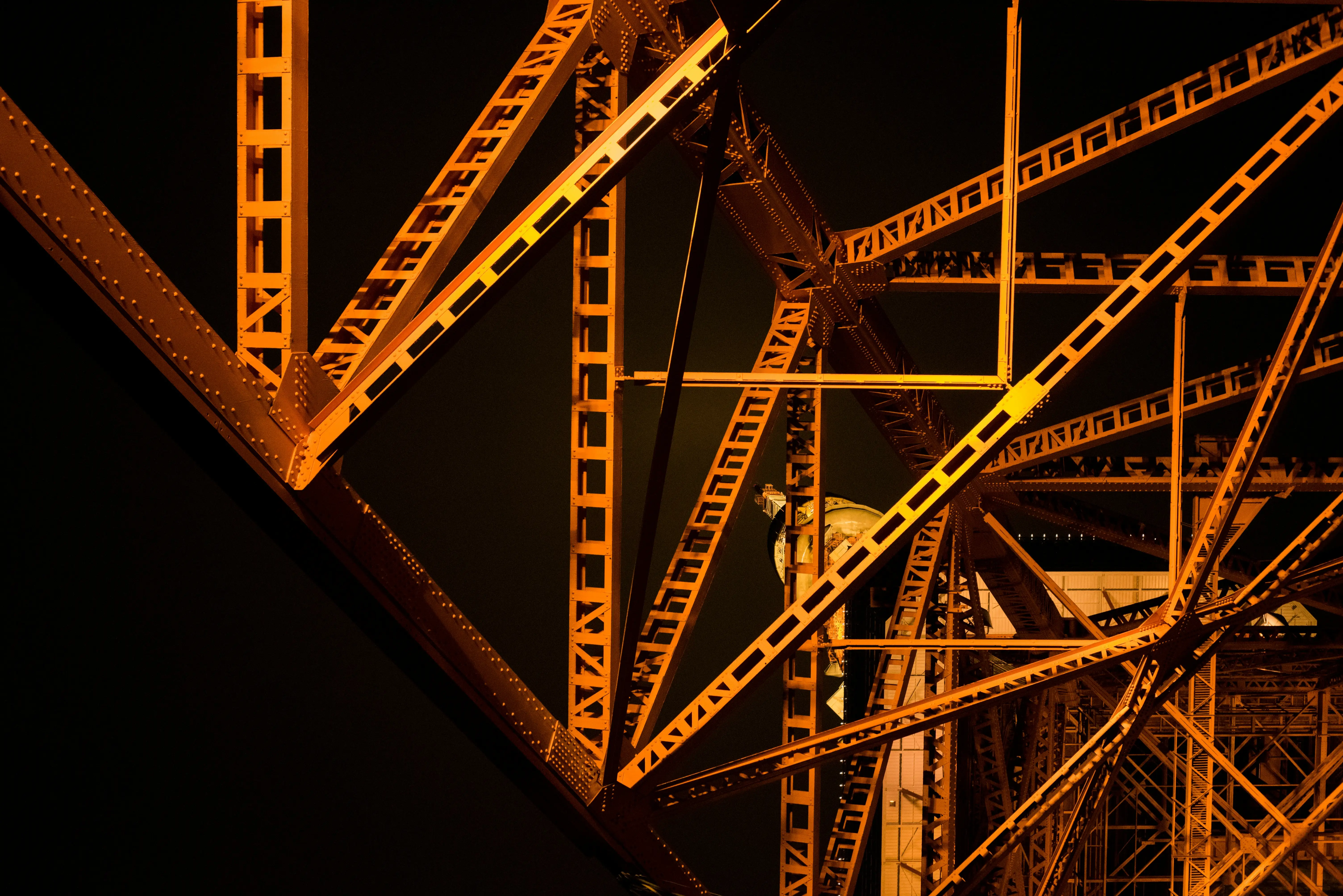 A person standing on a bridge with a yellow and orange background.