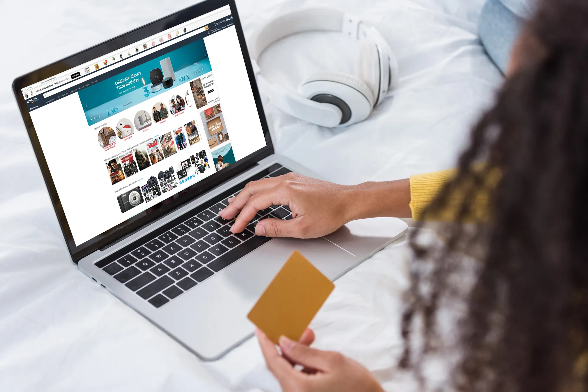 A person is using a laptop with a gold card in front of them.