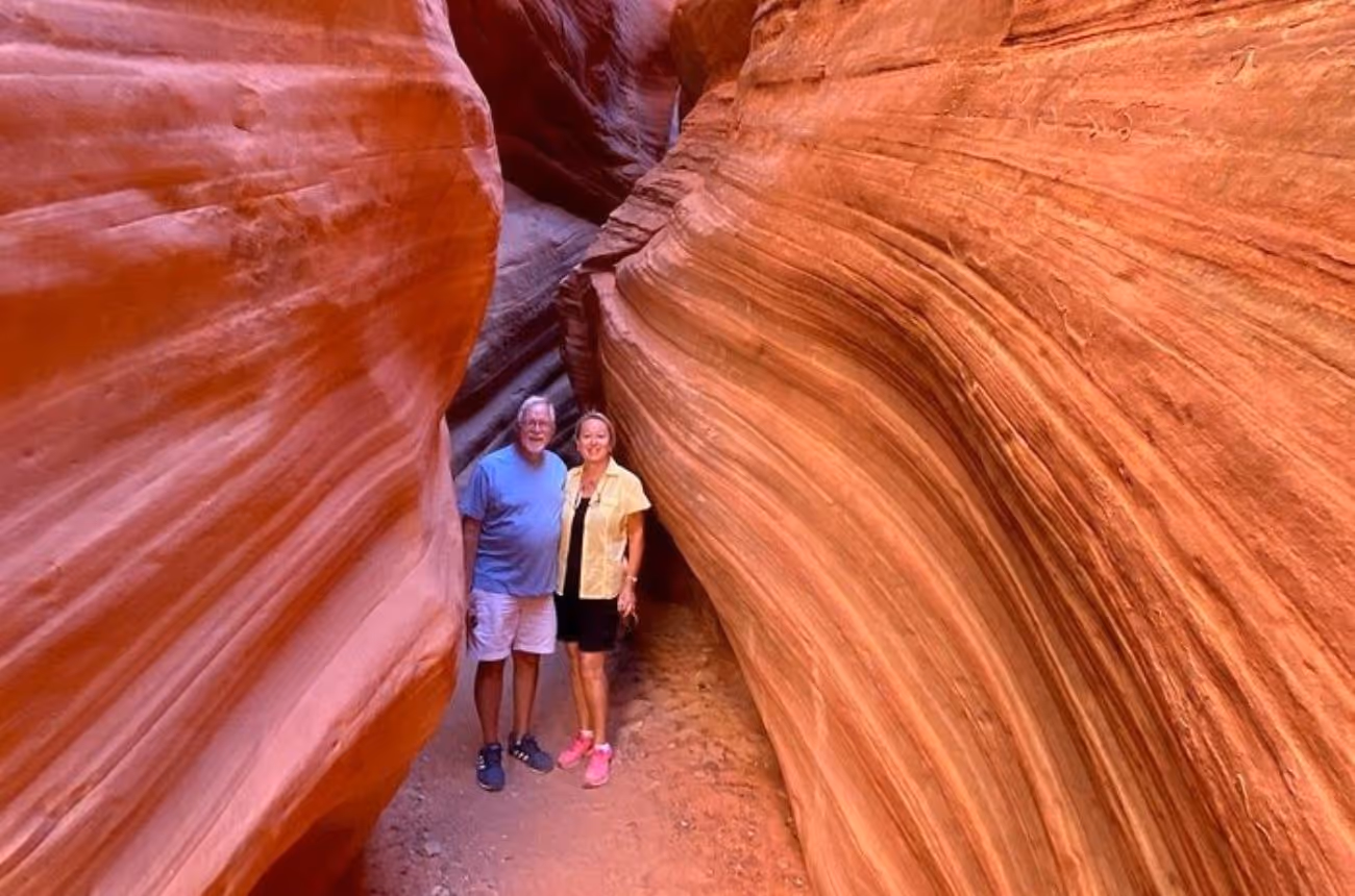 Experience an exhilarating UTV ride through Southern Utah's rugged terrain, leading to a guided hike through the mesmerizing Peekaboo Slot Canyon, renowned for its towering red rock walls and serene ambiance.