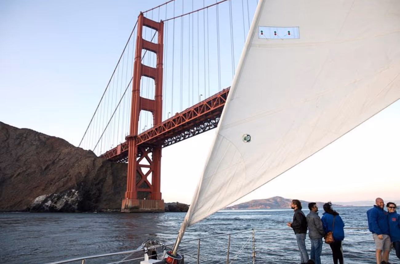 Set sail on a 1.5-hour catamaran cruise across San Francisco Bay, witnessing the city's skyline and iconic landmarks illuminated by the setting sun.