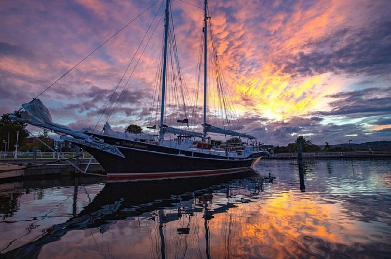 Enjoy a relaxing sunset cruise in Traverse City with stunning views, complimentary drinks, local treats, and expert narration about the historic schooner in a laid-back atmosphere.