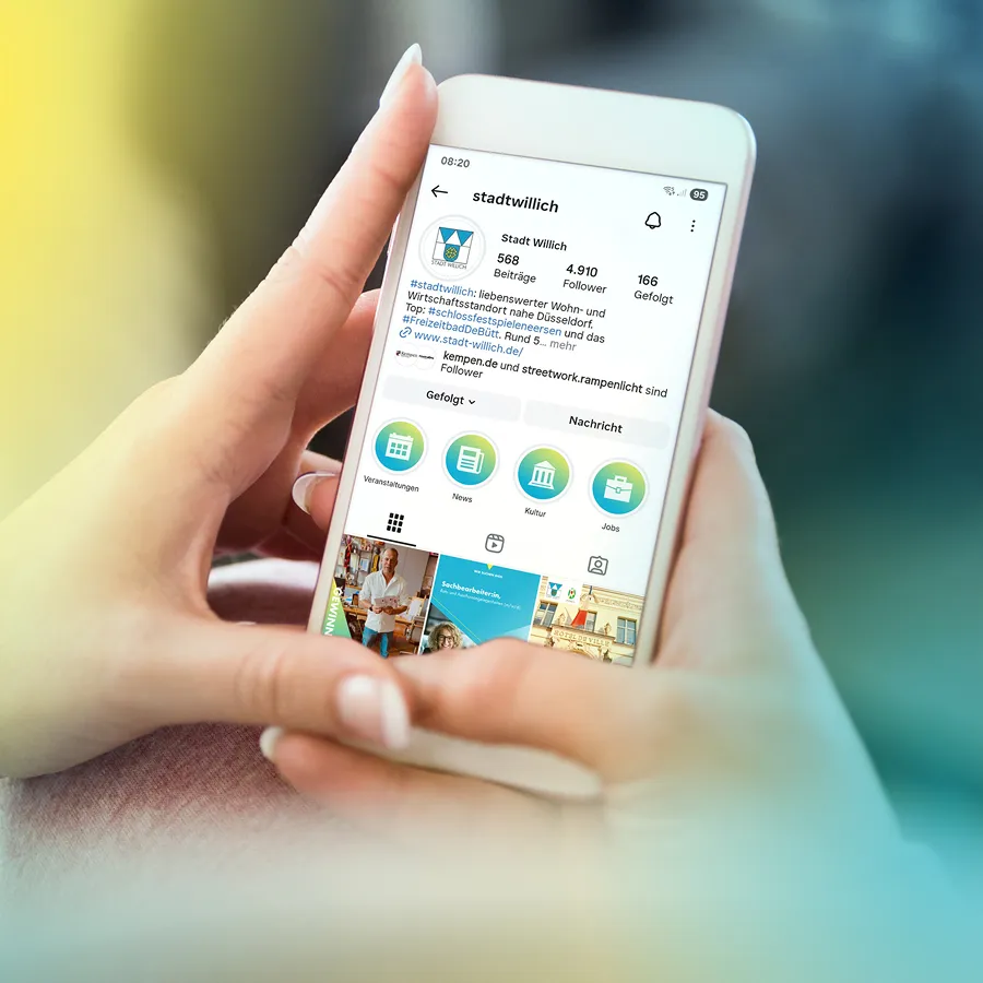 Smartphone shows the Instagram profile of the city of Willich with contributions, number of followers and categories such as events, news, culture and jobs.