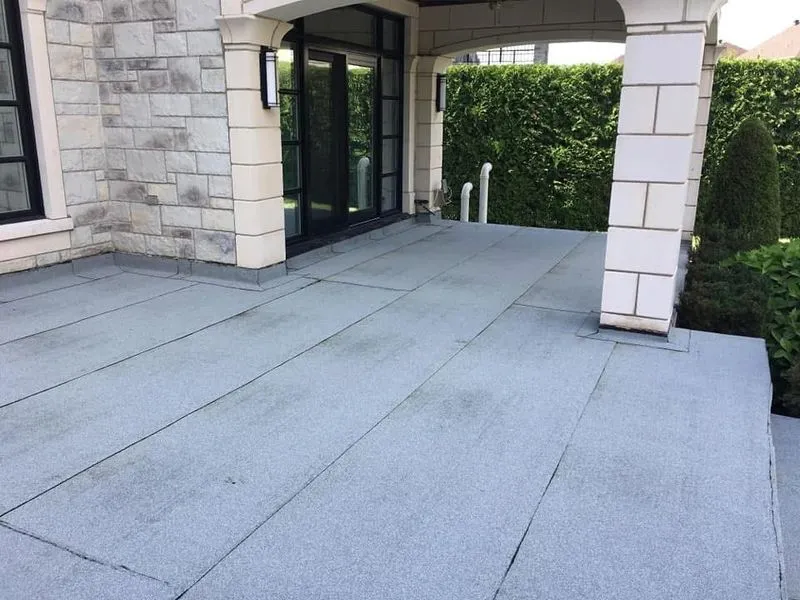 A roof with a gray covering.