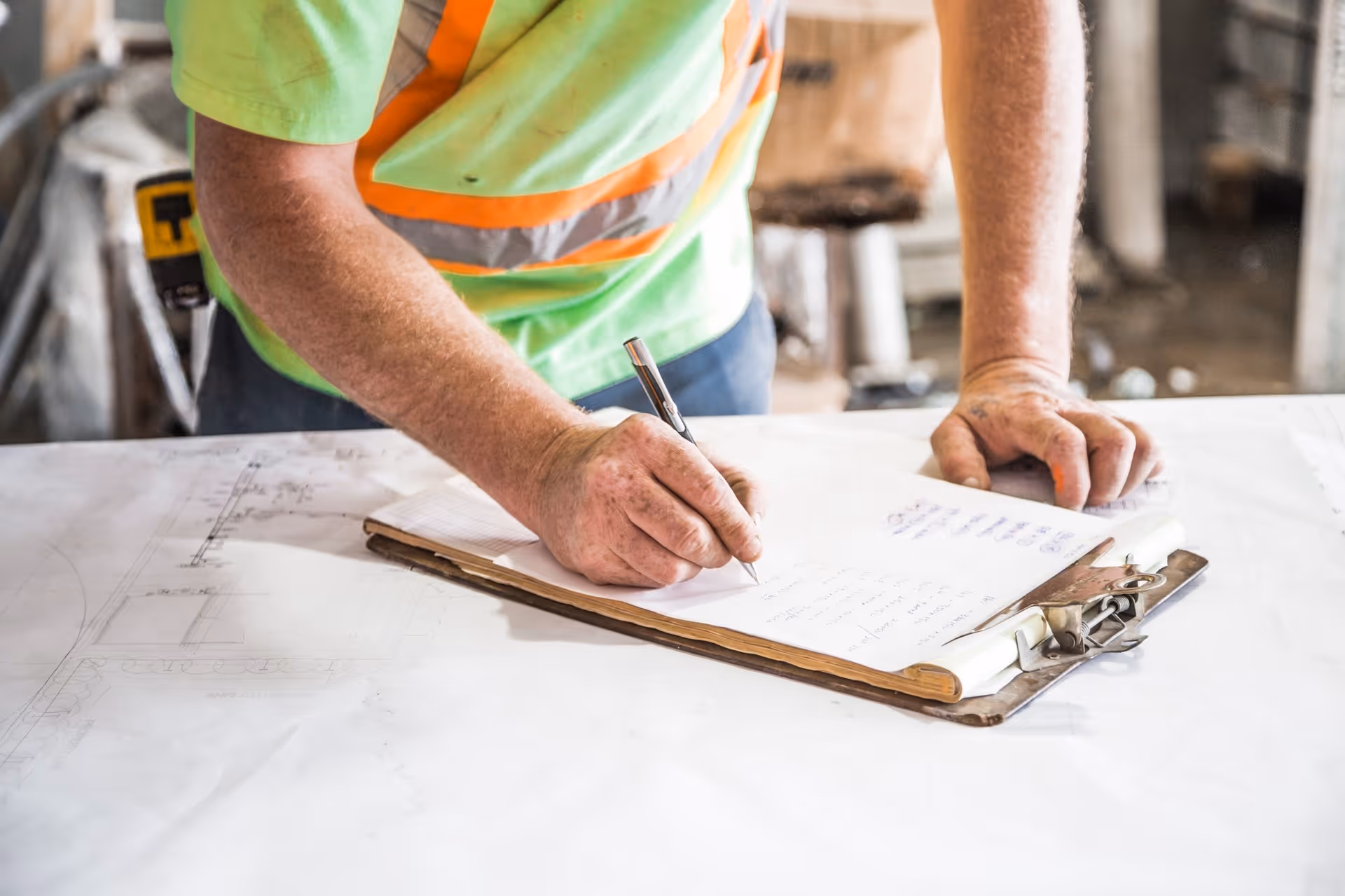 A man writing on a clipboard.