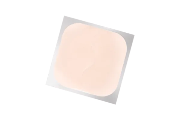Beige square birth control patch on a white background, a weekly hormonal contraceptive option