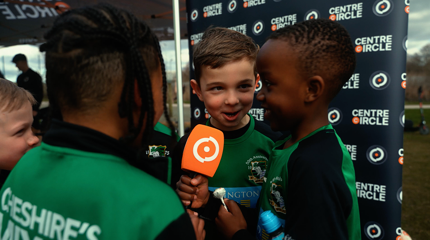 Kids in football kit with centre circle branding powered by ryft 