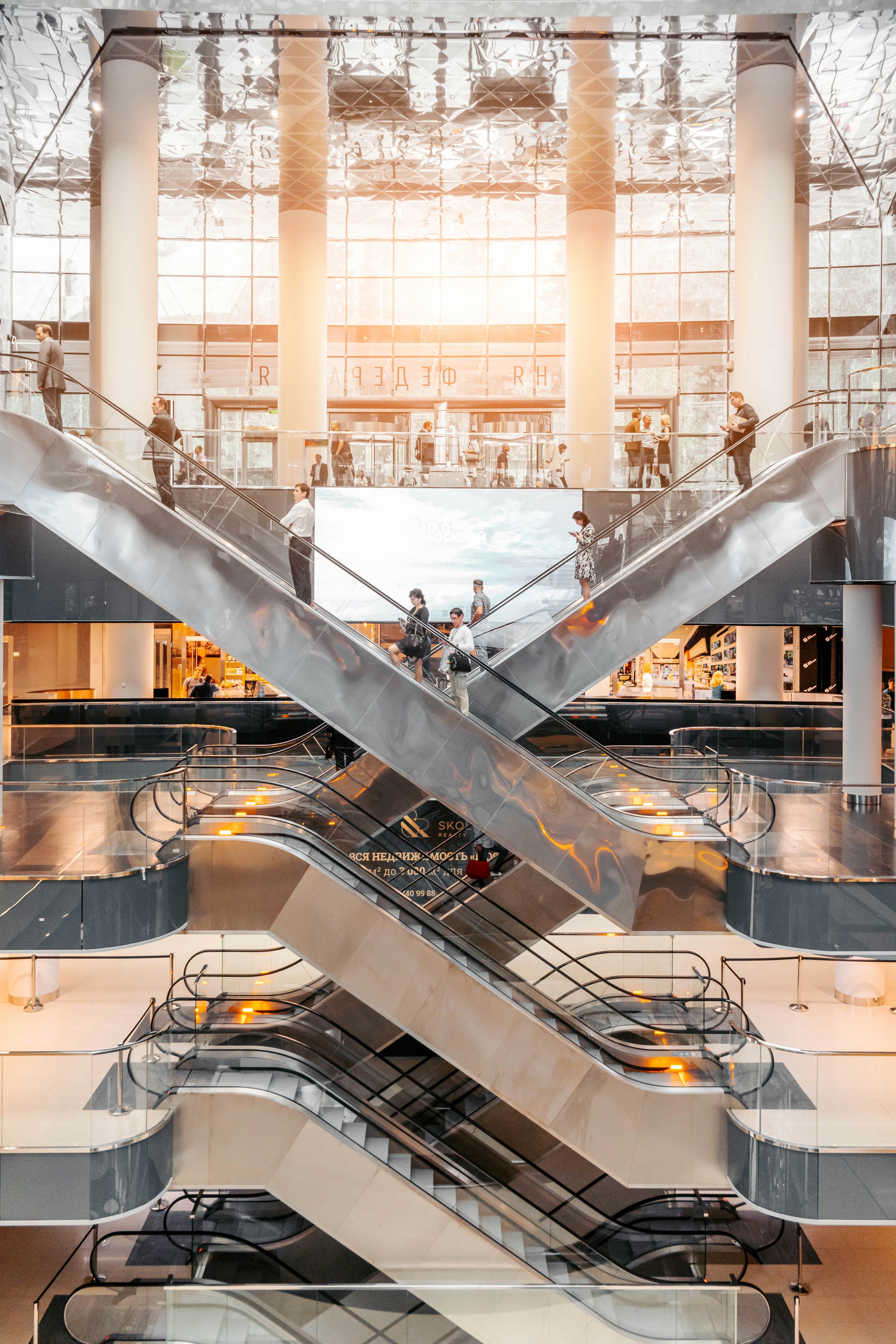 Shoppers walking through a UK shopping centre, where Tuck app users earn cashback at retailers like Tesco and Boots.