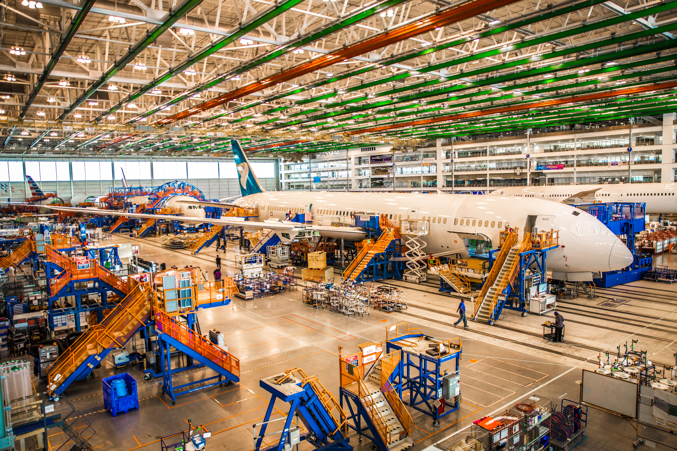 EGA aluminum smelter production line with workers inspecting equipment at industrial facility