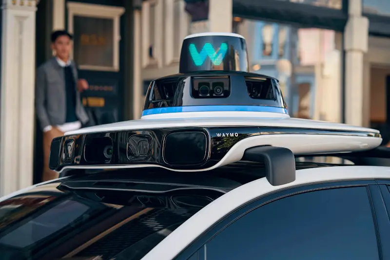 Waymo self-driving vehicle operating on a city street, illustrating advancements in autonomous transportation technology.