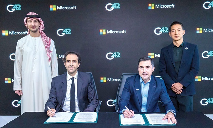 G42 and Microsoft executives signing strategic partnership agreement at ceremony with G42 and Microsoft branding