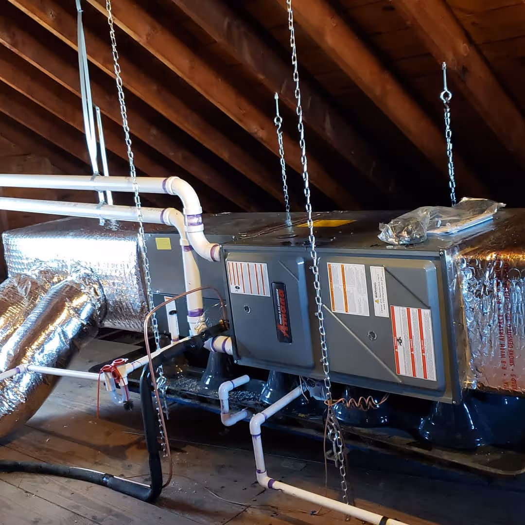 HVAC system with metal ductwork suspended in wooden attic space