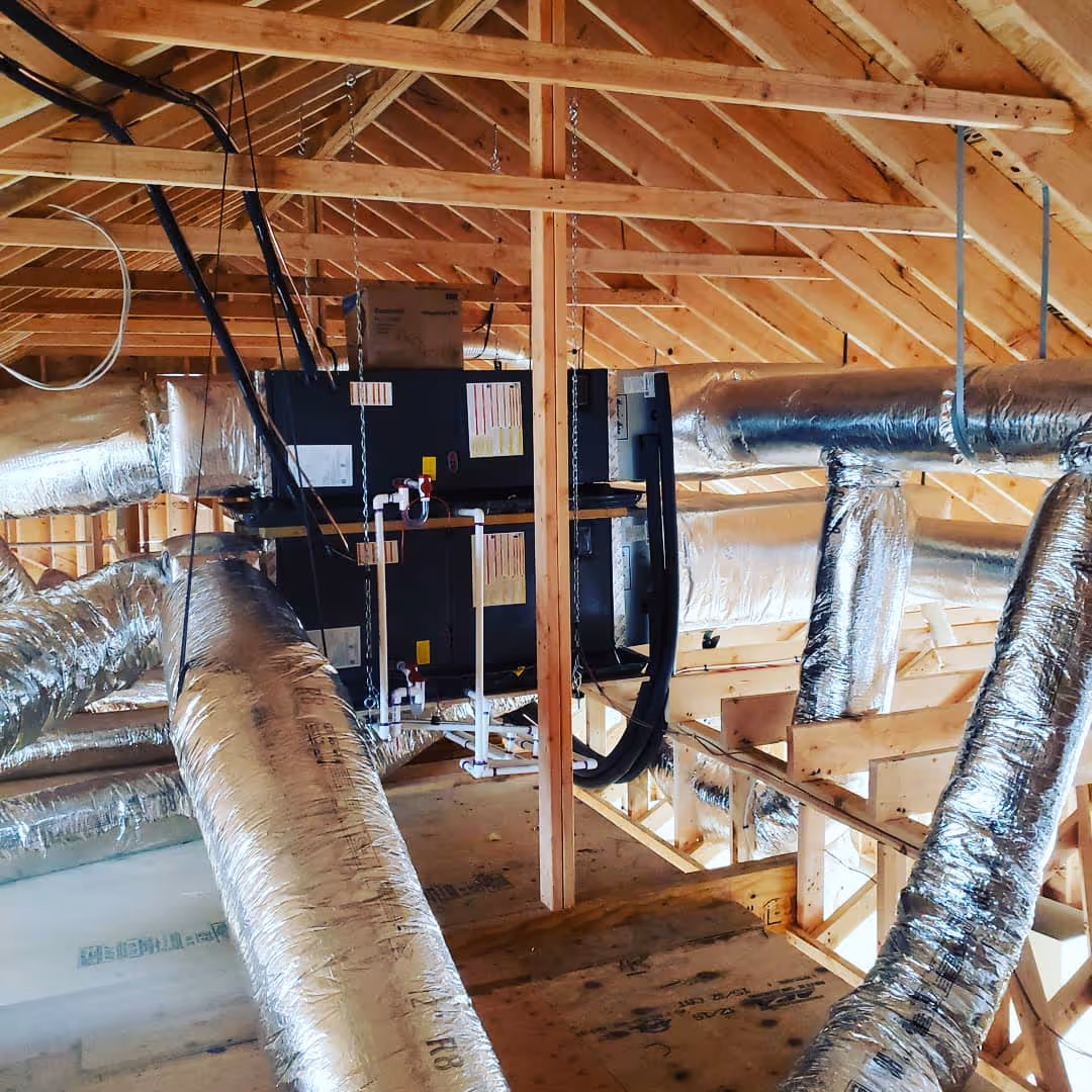 HVAC system and ductwork installed in wooden attic framing
