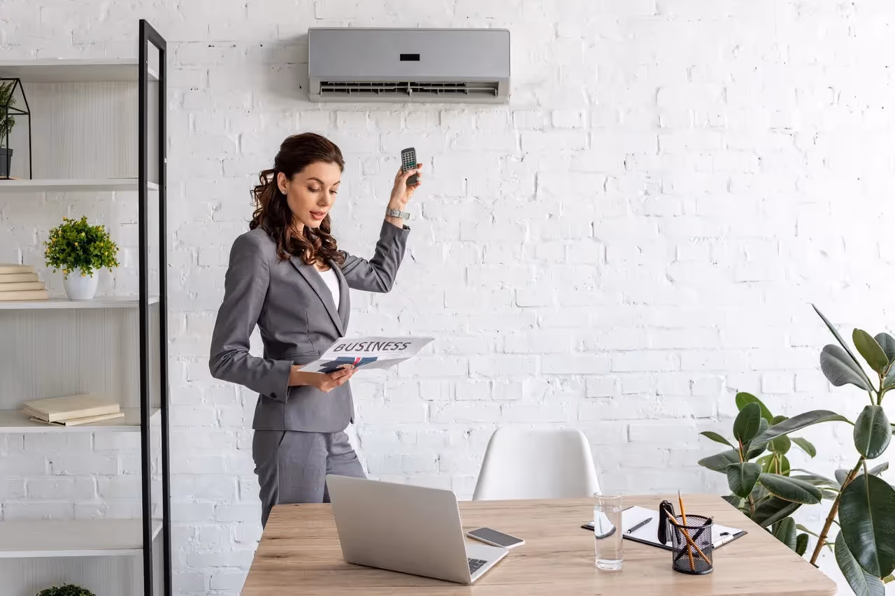 Professional woman in gray suit working in modern minimalist office