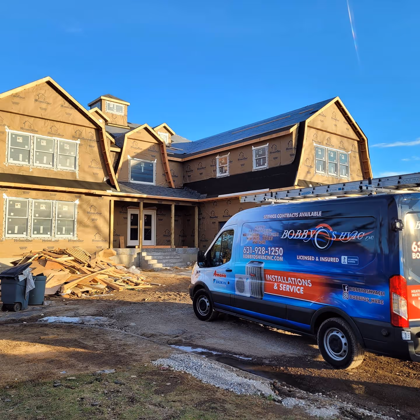 Bobby's HVAC van parked at a house under construction with construction debris