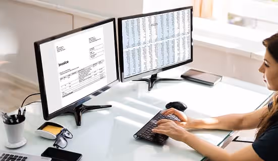 Close-up of hands counting money, with a stack of bills on the table, representing finance, savings, or payment.