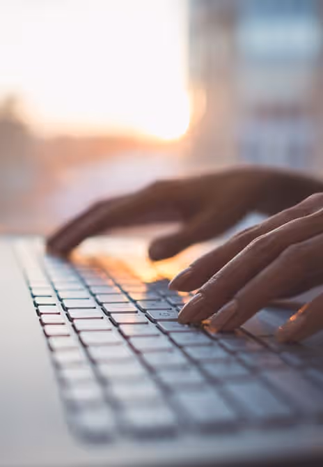 Close-up of hands typing on a keyboard, focusing on efficient and fast work.