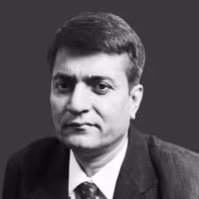 Boardroom setting with directors discussing financial reports, illustrating strategic planning and oversight.

