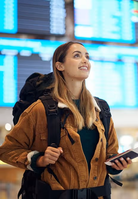 Female traveler holding a vintage camera and a map, ready to explore new destinations.