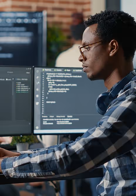 Beautiful woman working at her workplace, sitting at a desk with a laptop, smiling and focused on her tasks.