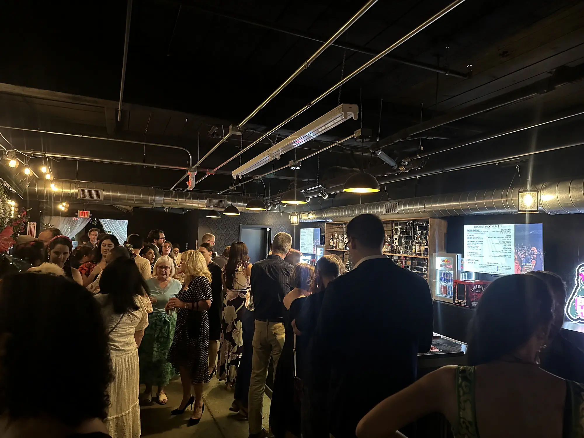Guests mingling in the main room during a private event at Taffeta Music Hall