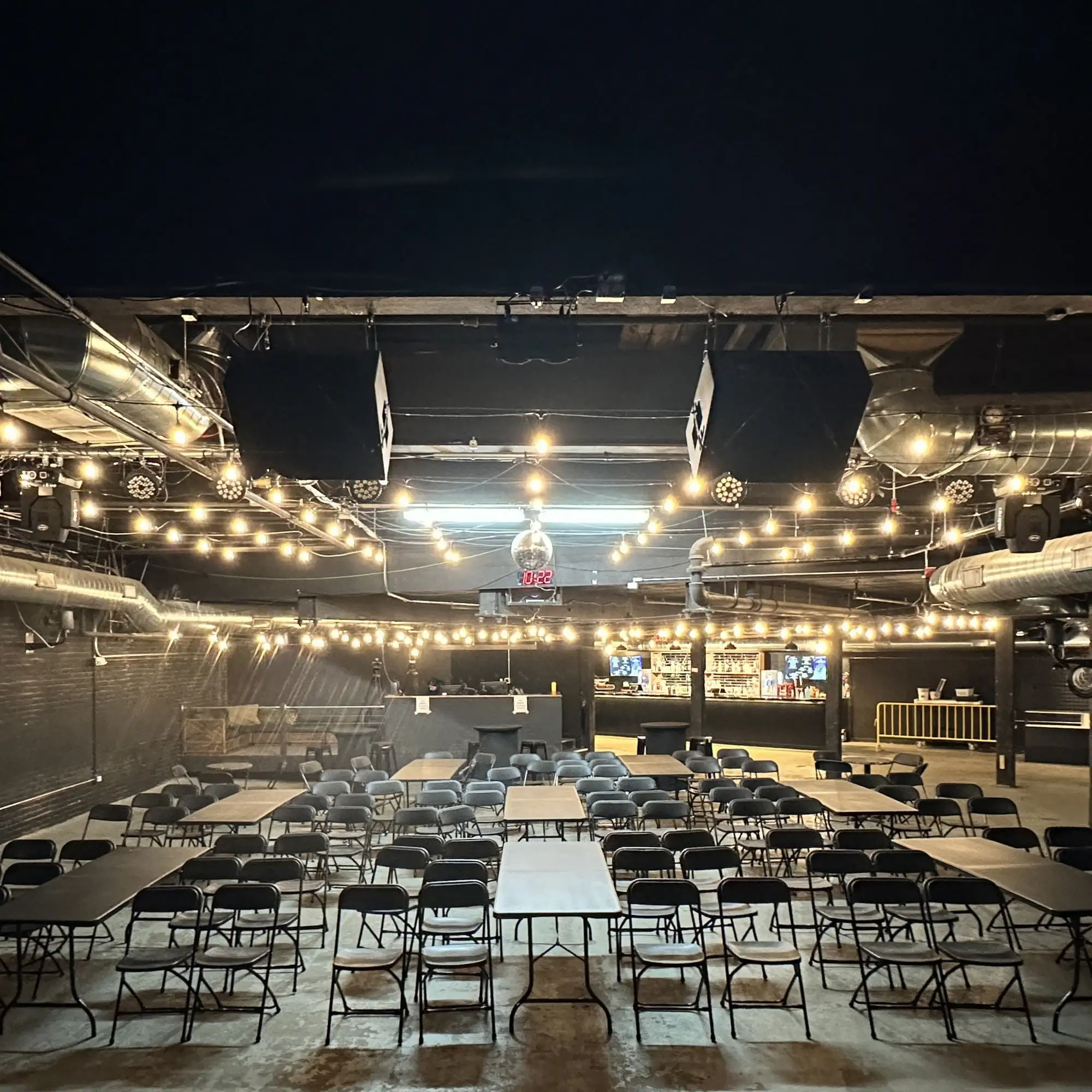 Banquet tables and chairs set up across the main room at Taffeta Music Hall