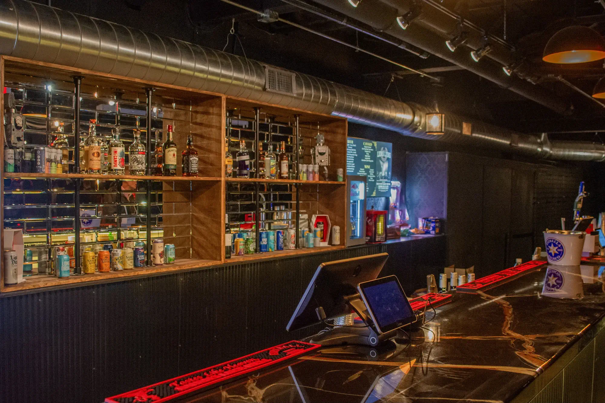 The bar with backlit liquor shelves at Taffeta Music Hall
