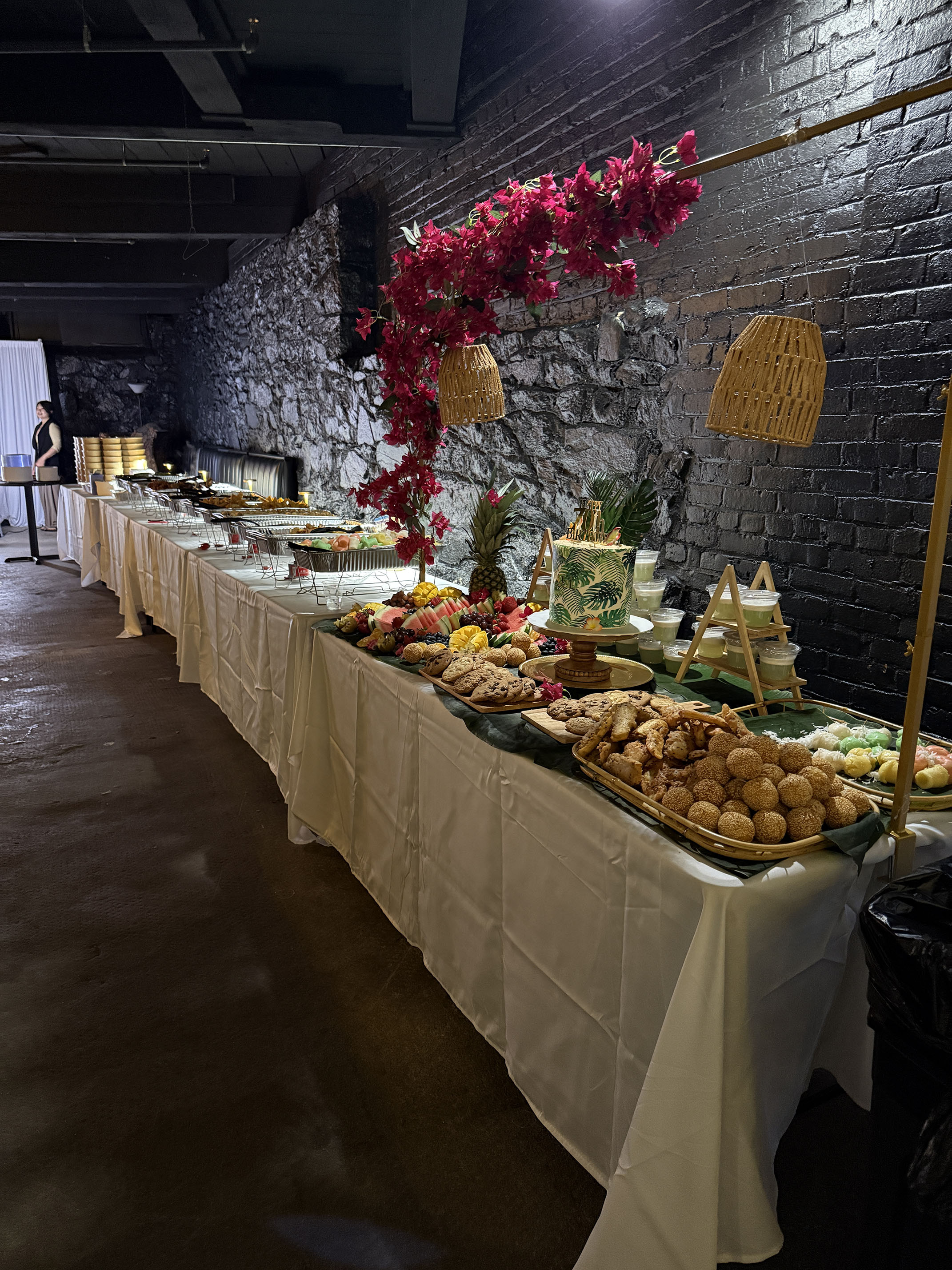 A long catered buffet table along the brick wall at Taffeta Music Hall