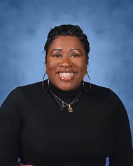 Ms. Reese smiling in staff directory portrait photo