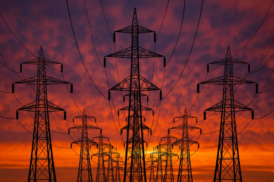High voltage transmission lines at sunset