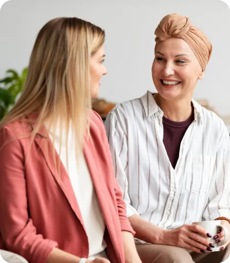Two women talking together in a relaxed setting.