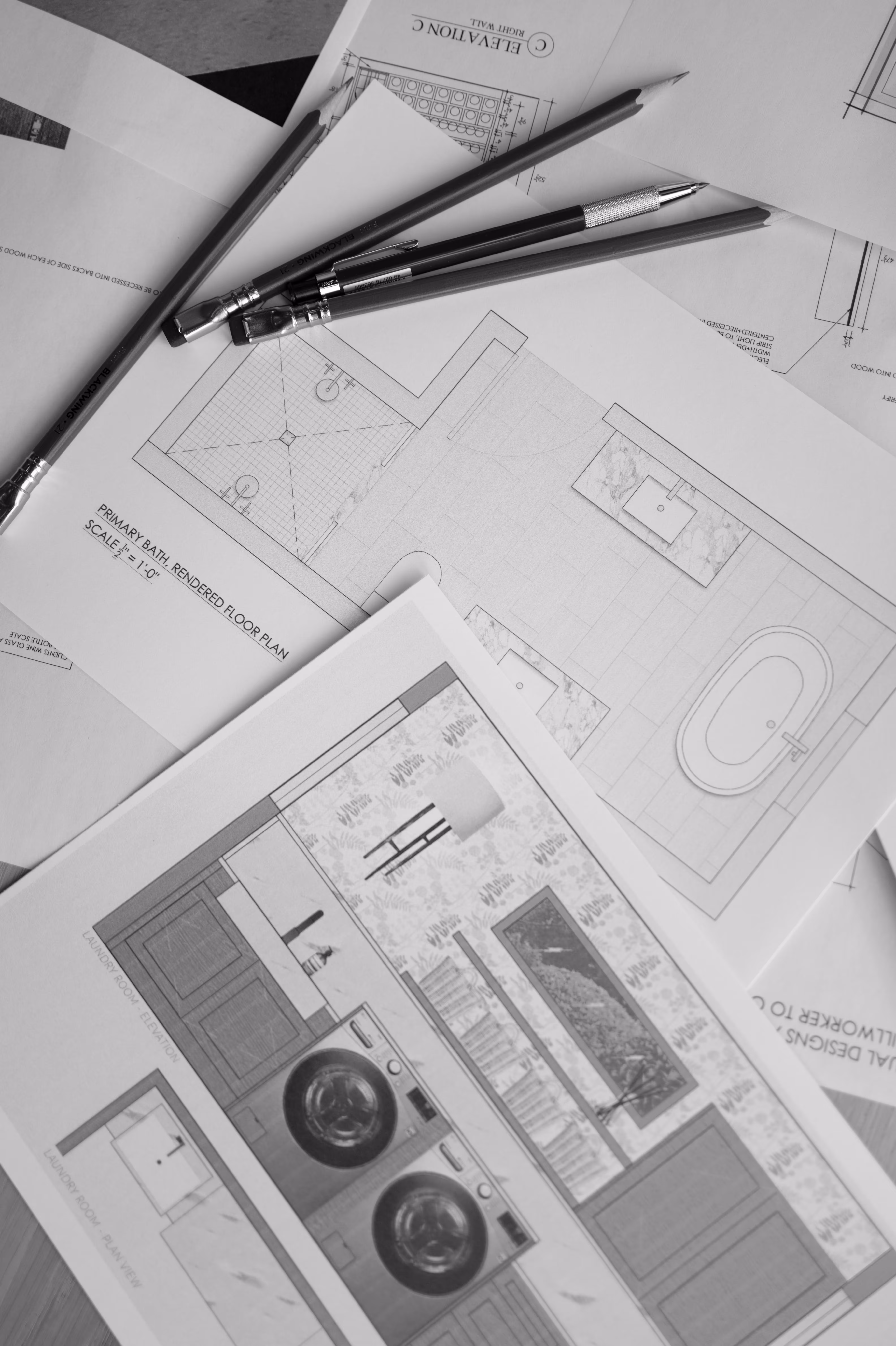 Bathroom and laundry design blueprints with pencils