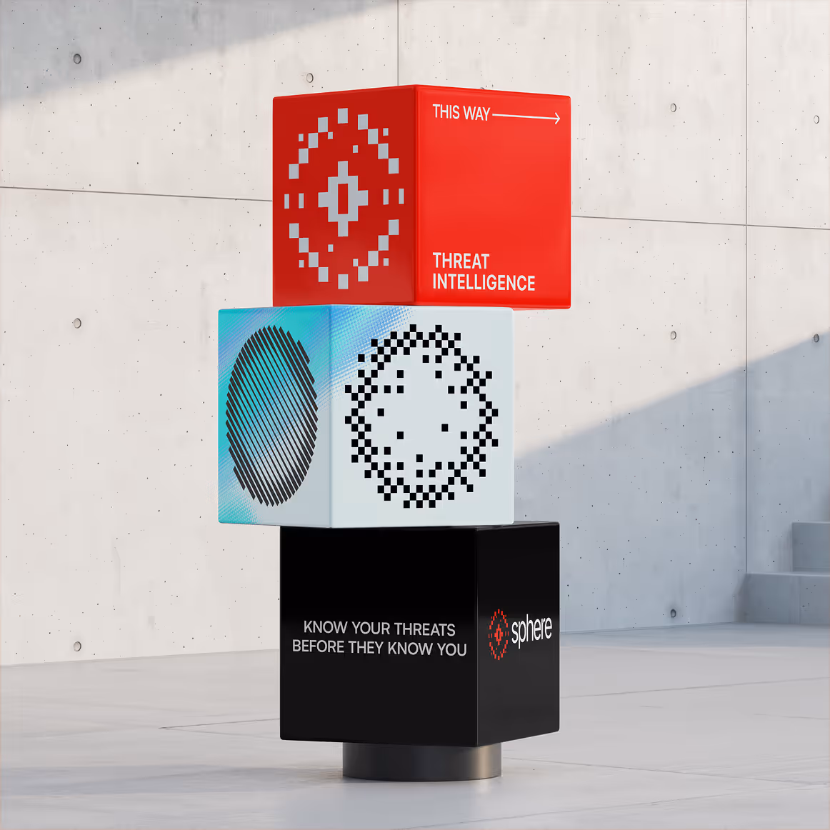 Stacked red, white, and black cubes with cyber threat intelligence logos and the text 'THIS WAY -> THREAT INTELLIGENCE' and 'KNOW YOUR THREATS BEFORE THEY KNOW YOU' beside a modern concrete wall.