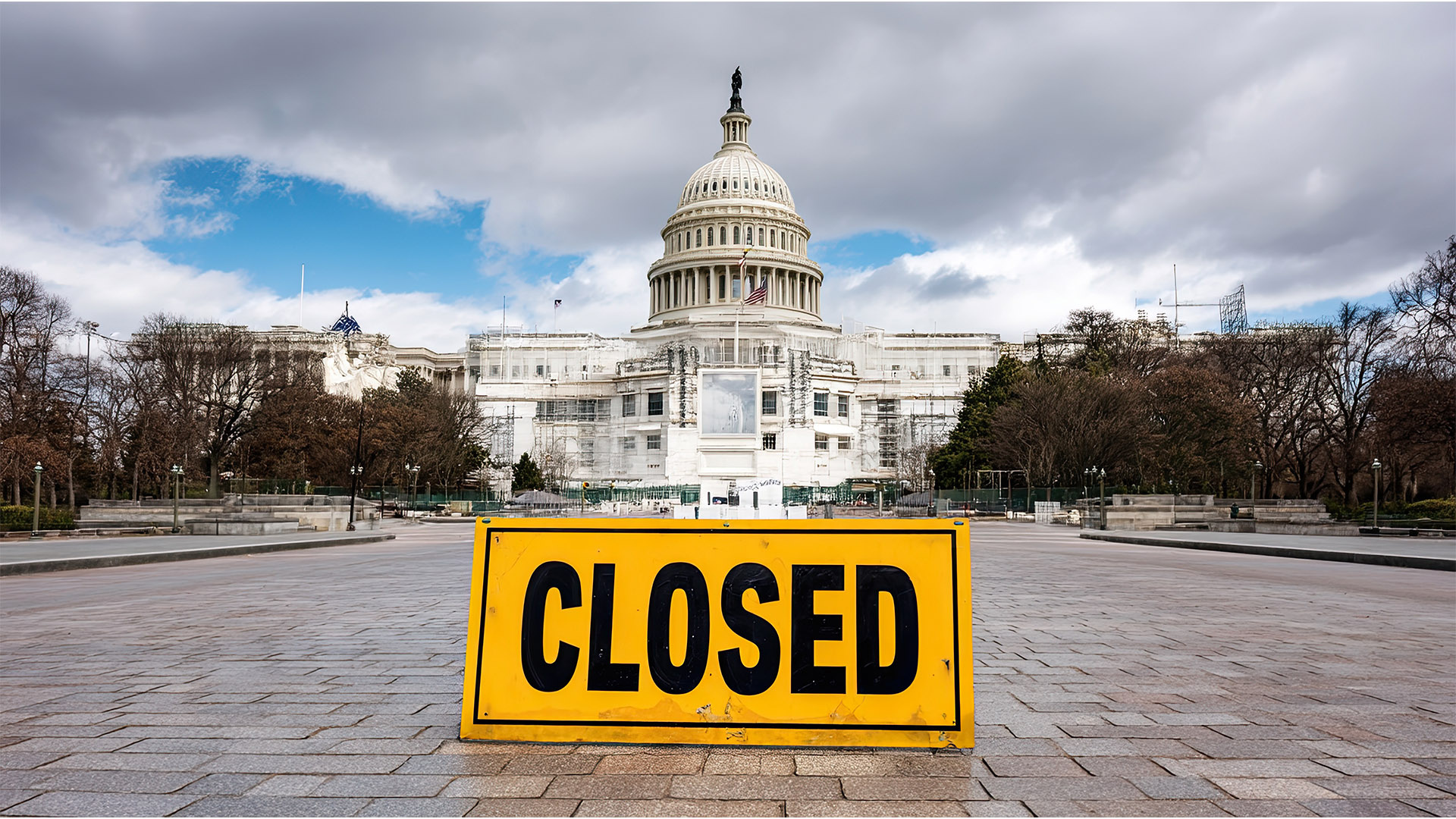 Yellow closed sign in front of US Capitol Building with empty plaza