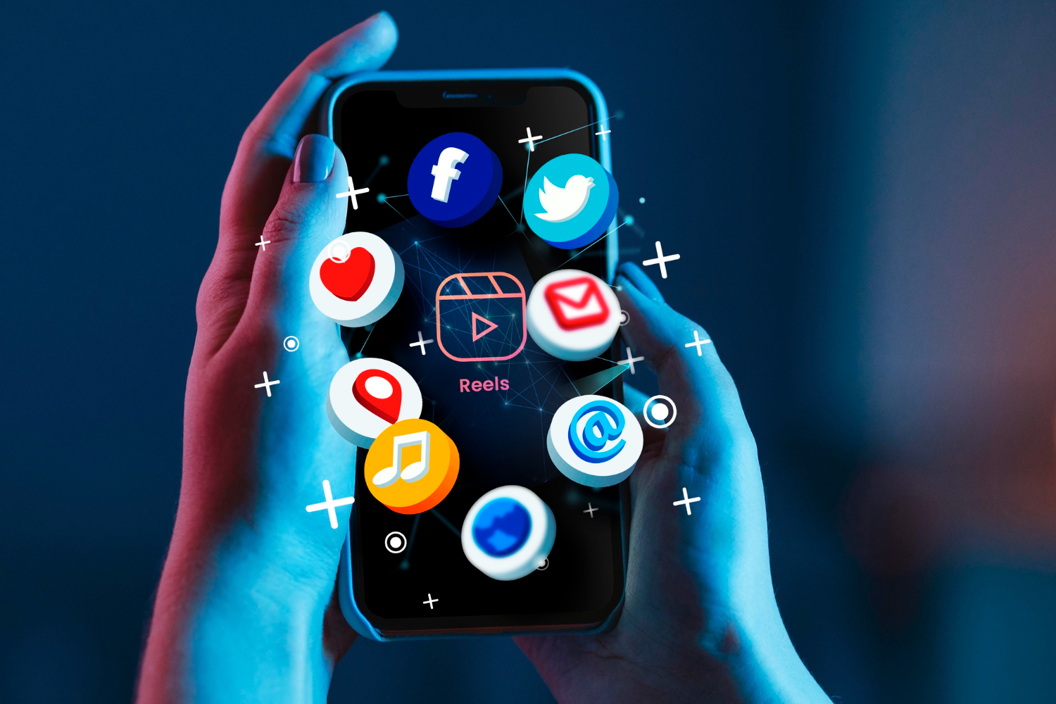 Hands holding smartphone displaying social media app icons including Facebook, Twitter, and Reels