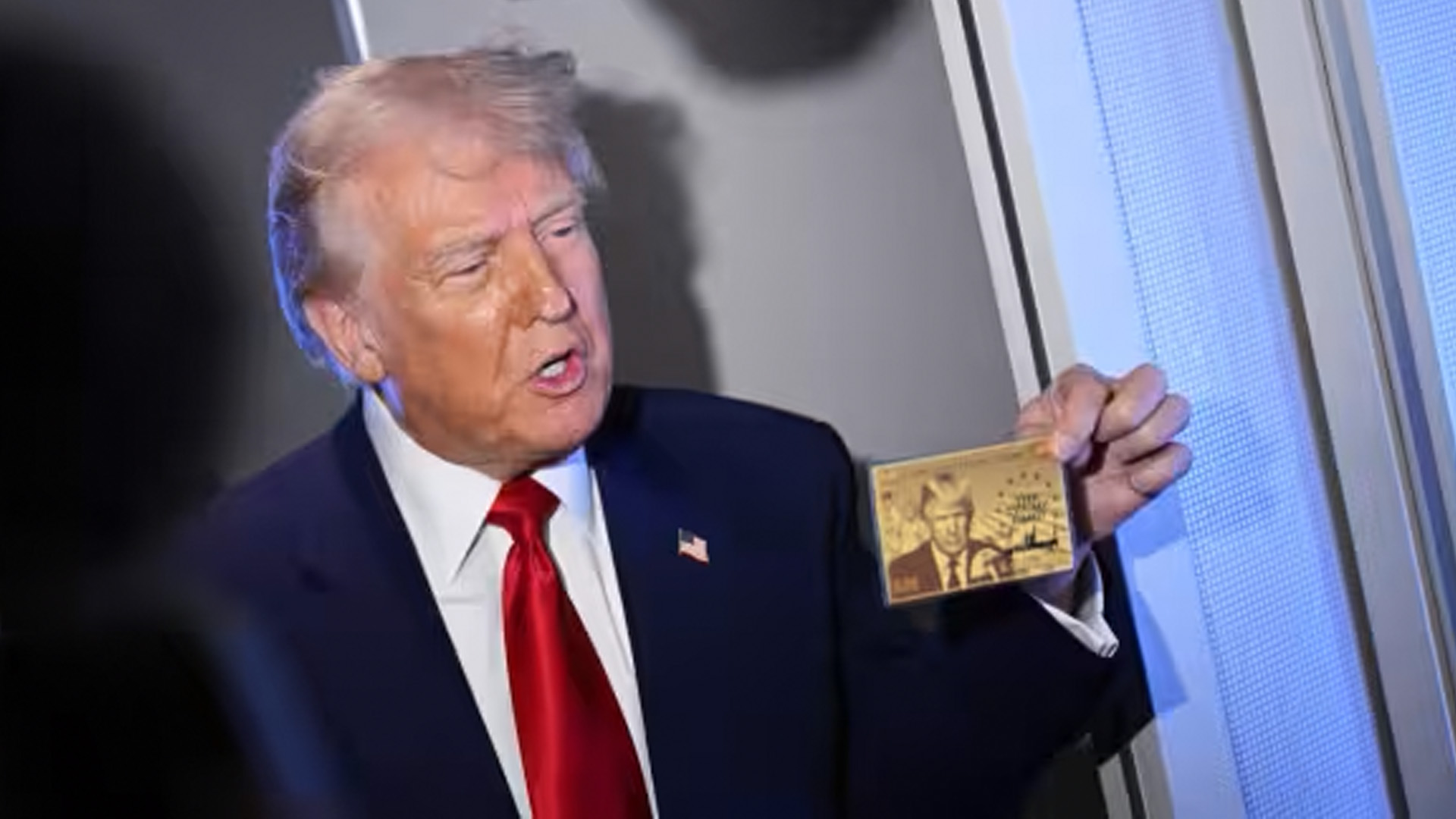 President Trump displays a gold colored card, new gold card immigrant visa program