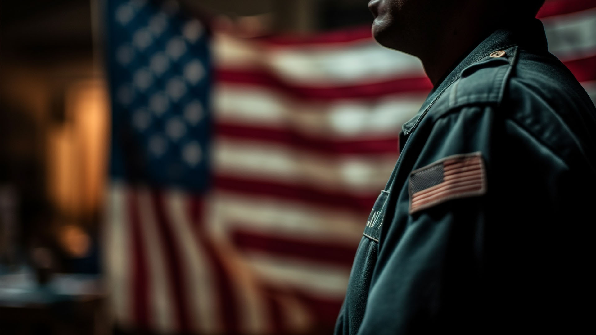 Officer in uniform with American flag patch before a blurred US flag, visa bond pilot program news