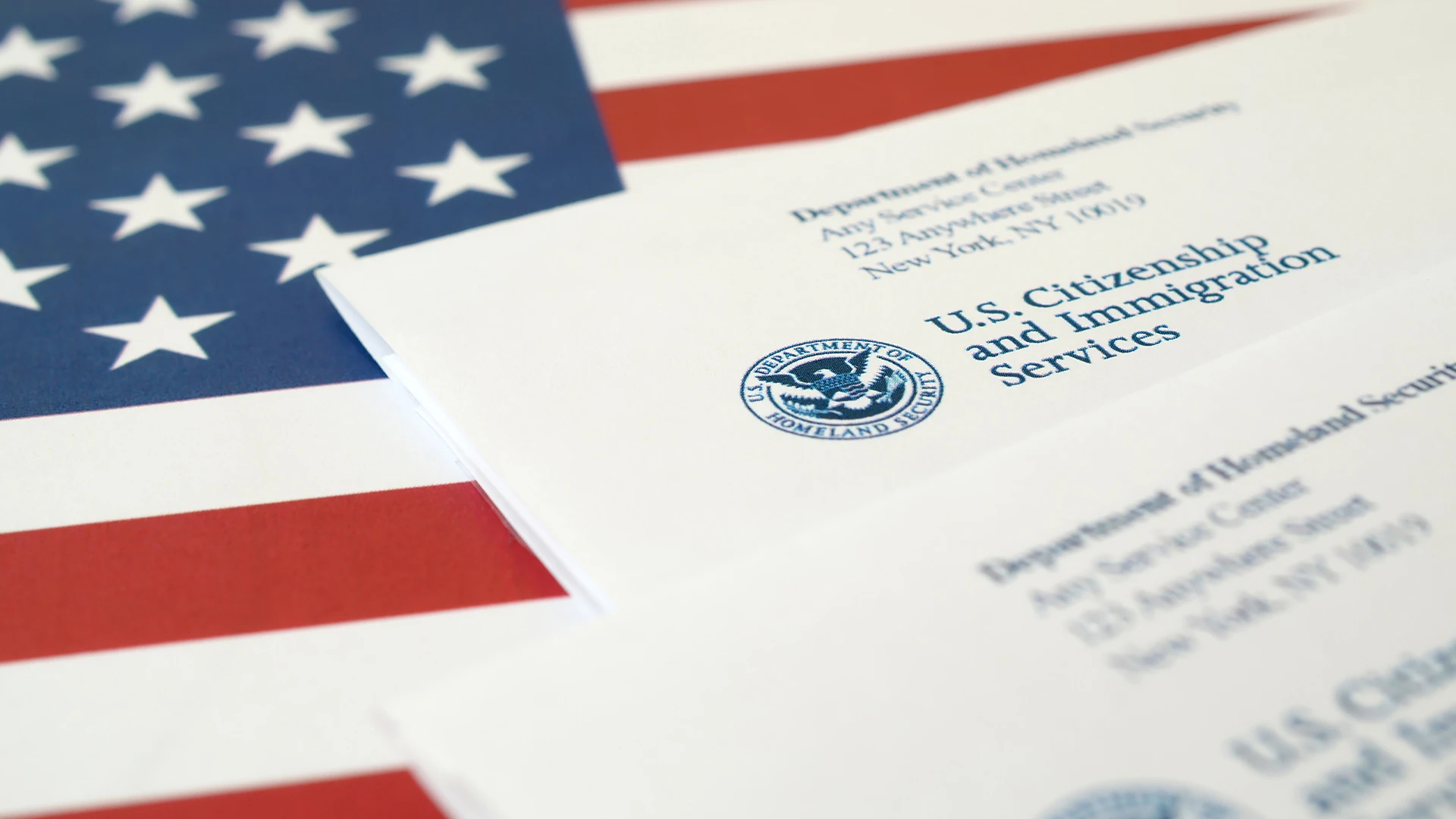 USCIS letters on an American flag, adjustment of status limited to extraordinary circumstances