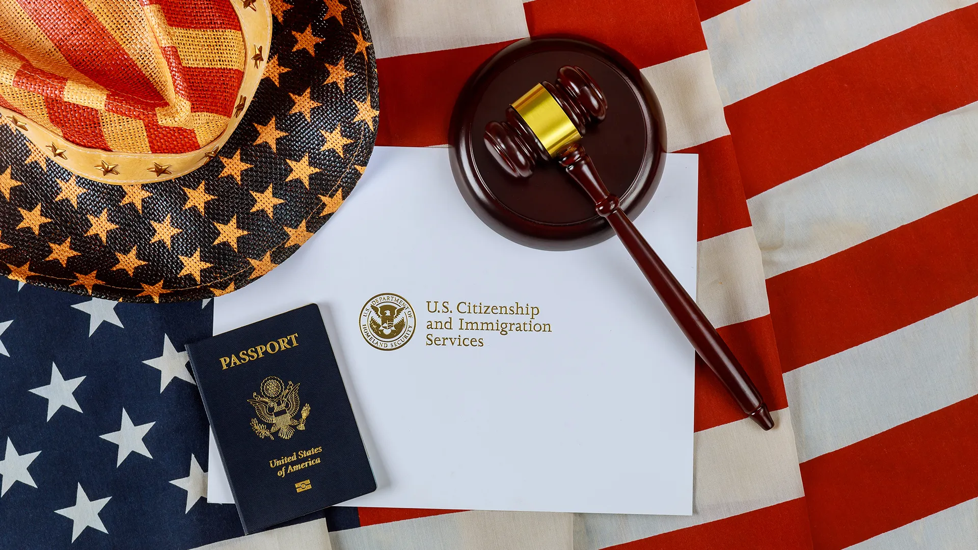 Wooden gavel and US passport on a USCIS letter over the American flag, USCIS new fees announcement