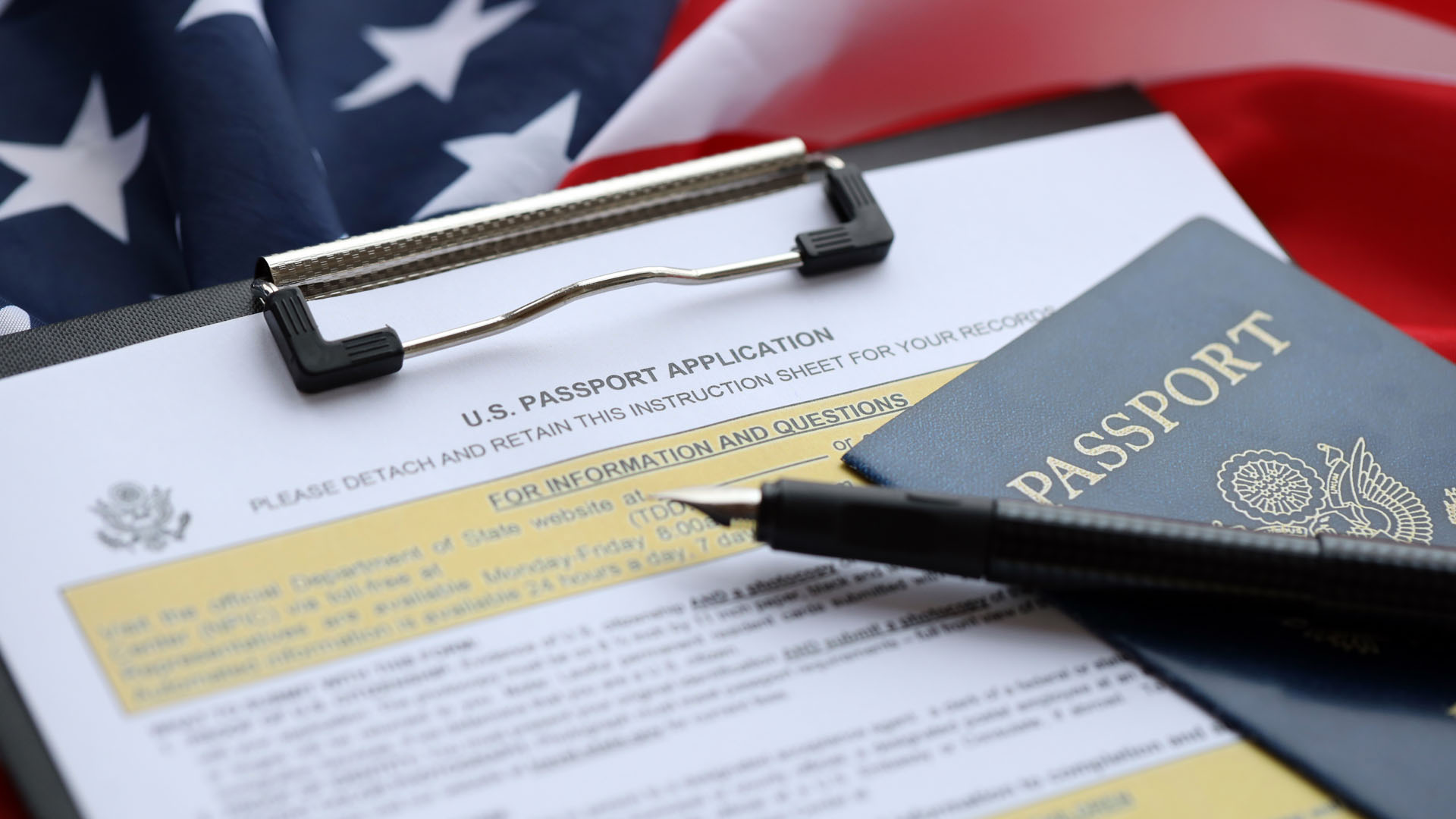 US passport application form with passport and pen on an American flag, naturalization good moral character policy