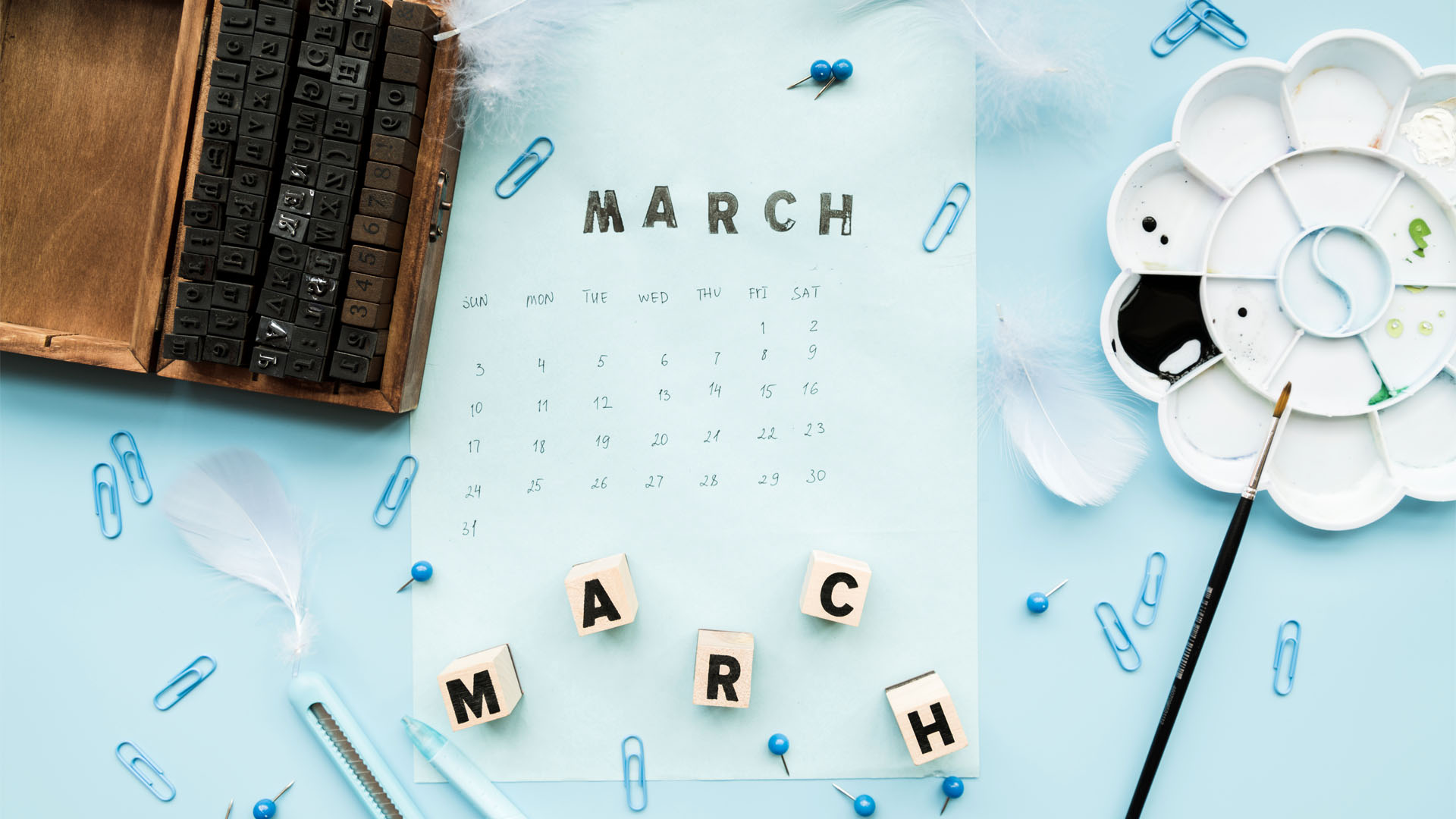 March calendar page with letter blocks and paint palette on blue, March 2026 visa bulletin