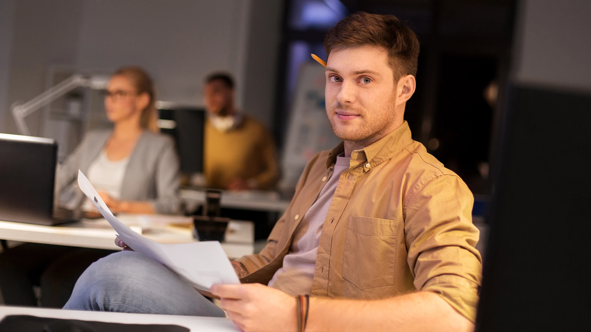 Person reviewing immigration paperwork at a desk, USCIS interim final rule on mandatory online filing