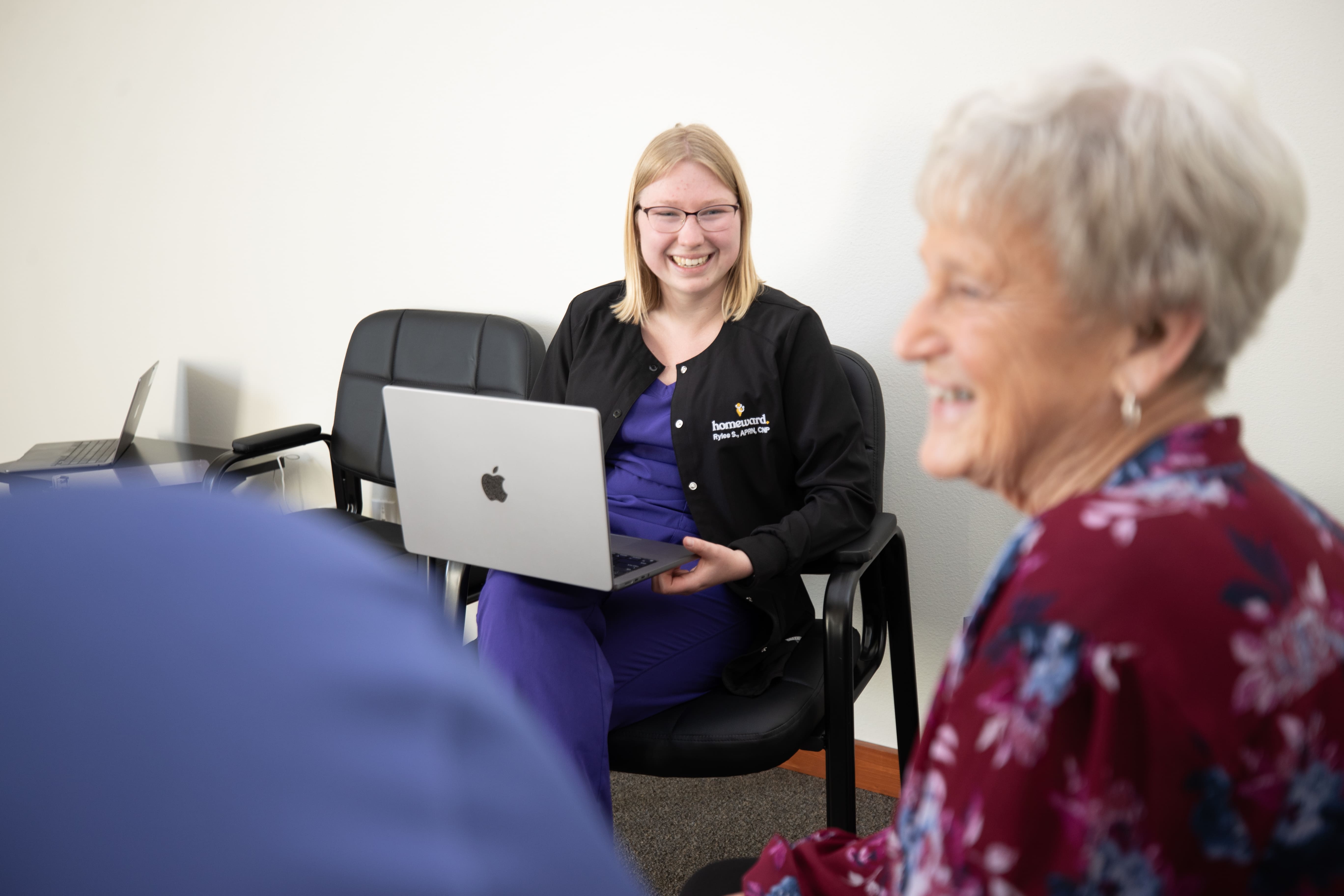 A care navigator smiling at a female elder