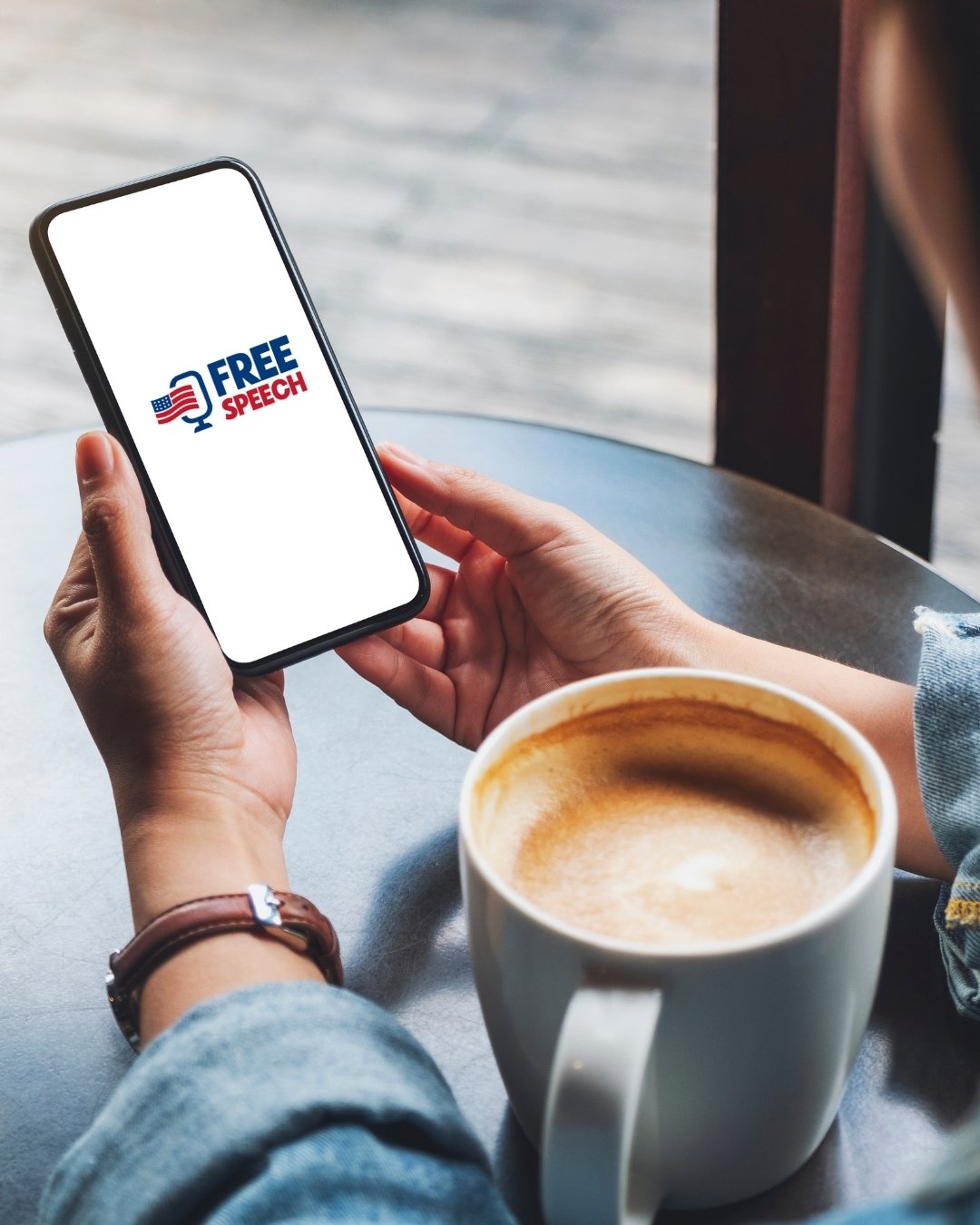 a men is seeing the Free Speech app on his  phone