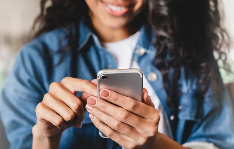 Girl smiling looking at phone