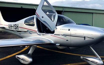 VH-YSH on the ramp beside the hangar