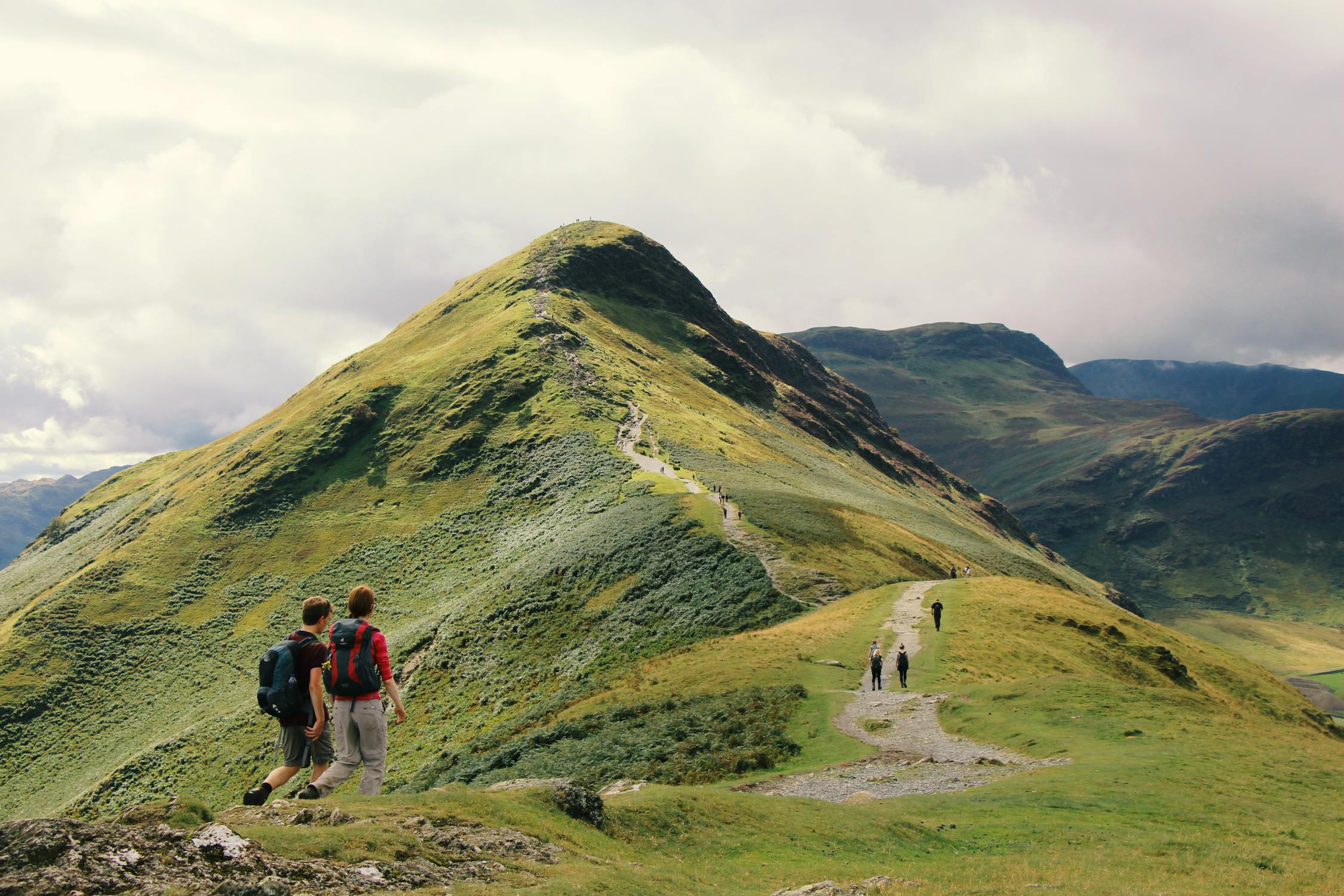 Picture of people hiking a mountain in the UK, by Rachel Vine