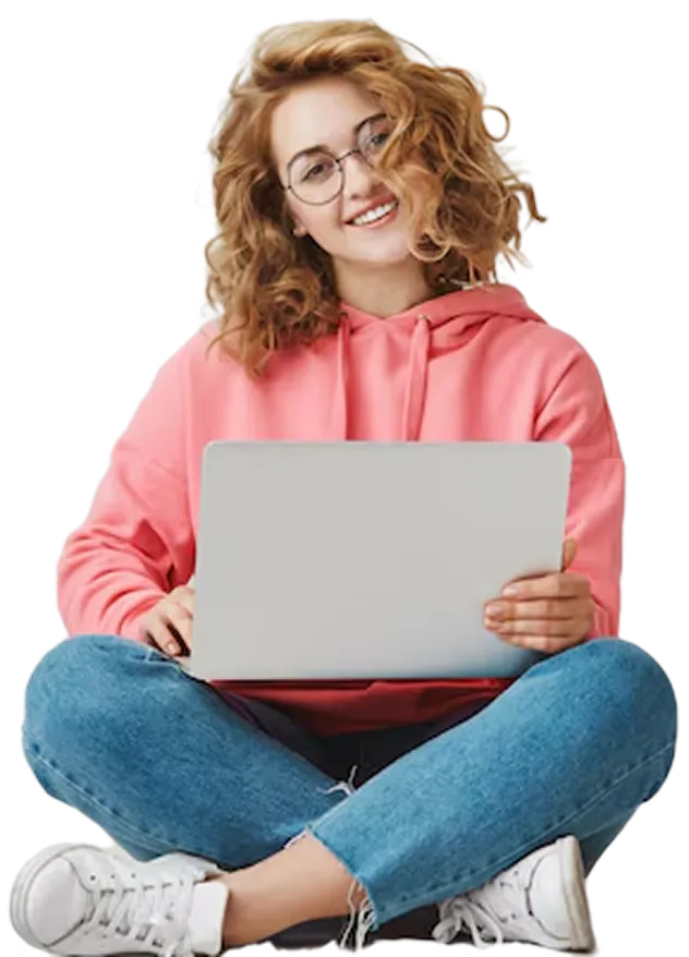 A woman sitting on the floor with a laptop.