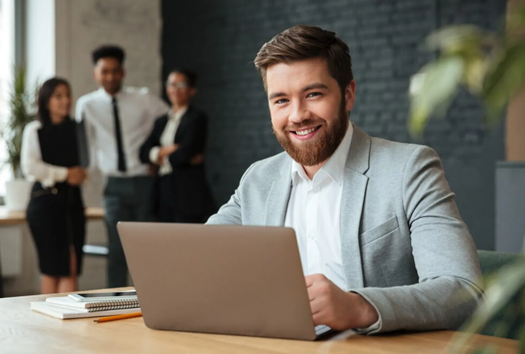 A man sitting in front of a laptop computer.