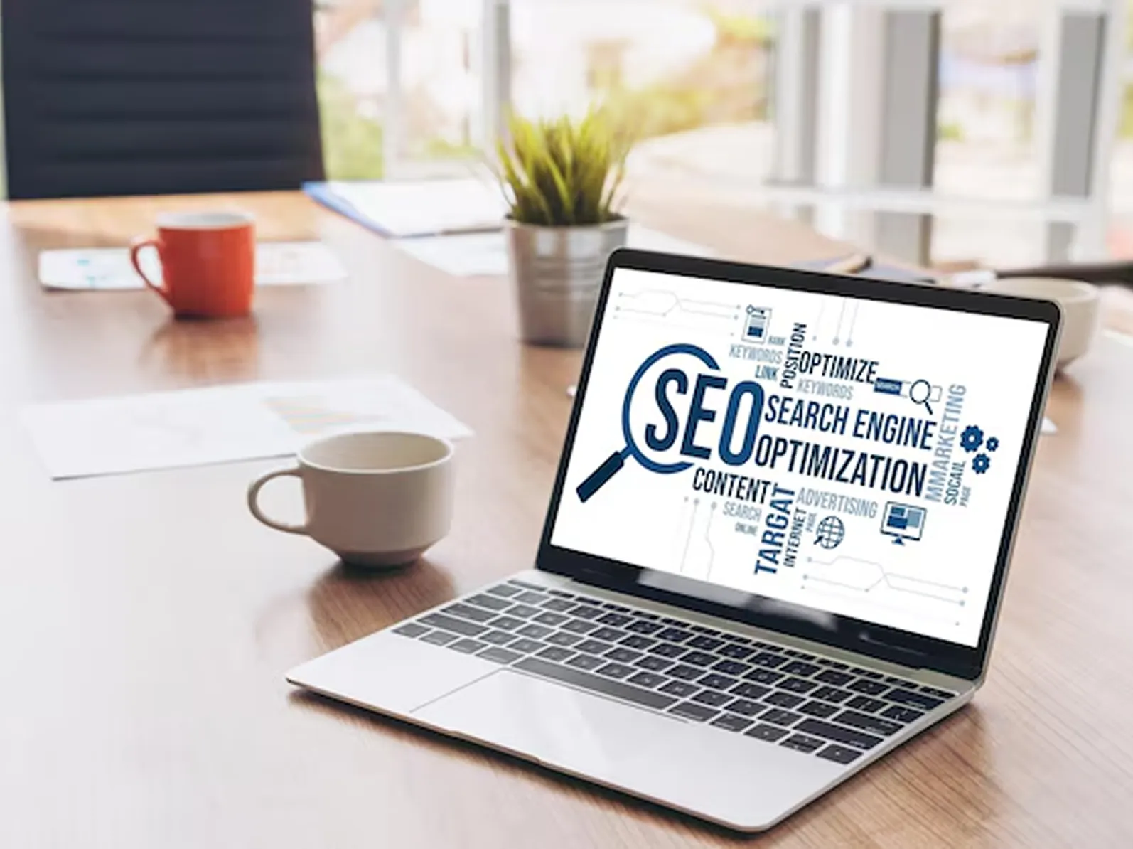 A laptop computer sitting on top of a wooden table.